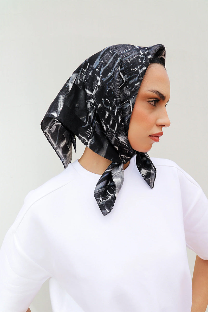 Elegant silk Charkol scarf by Amel Batita featuring intricate patterns, perfect as a stylish headscarf or shawl accessory.
