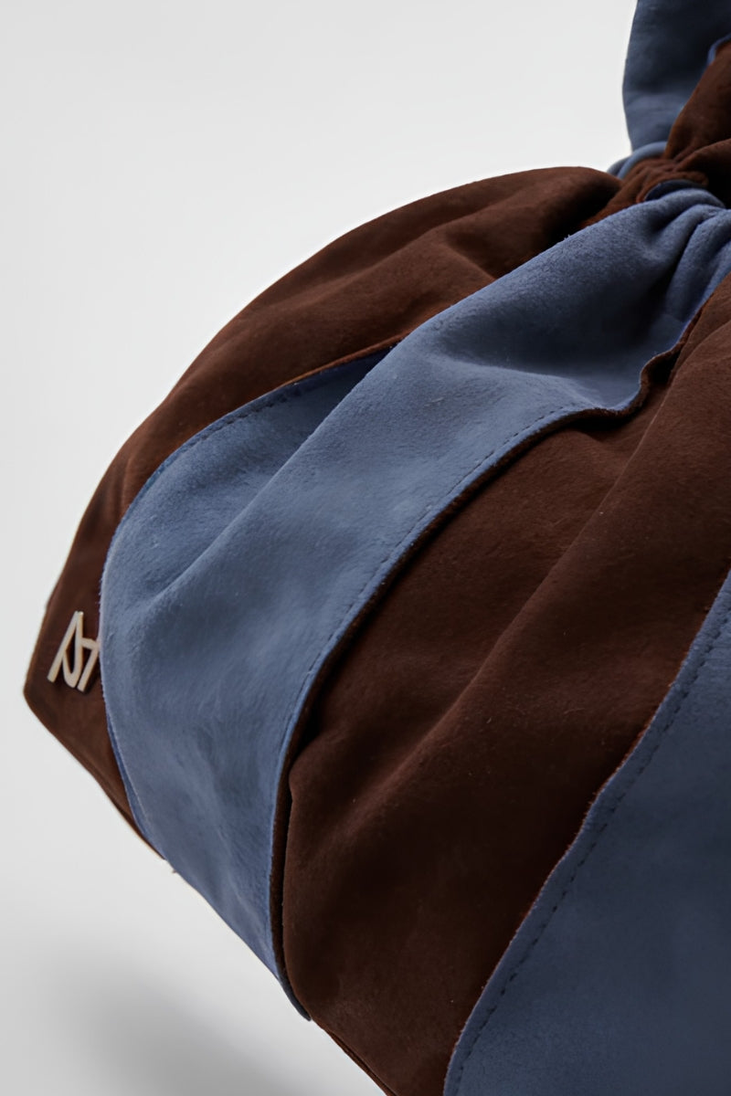 Blue Double A Charlie II suede shoulder bag with sleek design and top handle, featuring a stylish and versatile accessory.