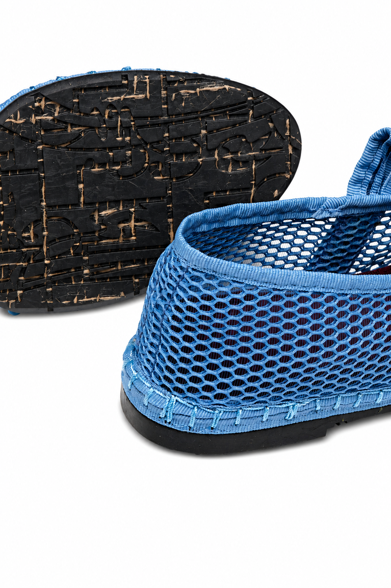 Flabelus Isabella blue flats showing rounded toe, slip-on style, and soft fabric upper on a neutral background.