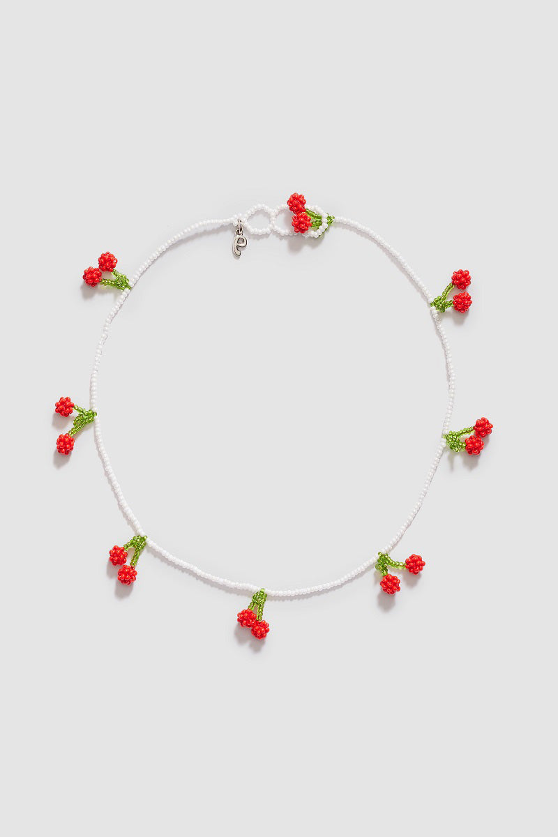 Pura Utz cherry pendant necklace featuring a bright red cherry charm on a delicate chain.