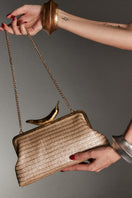 Gold chili straw classic clutch by Sarah's Bag with gold-toned straw exterior and elegant design for evening occasions.