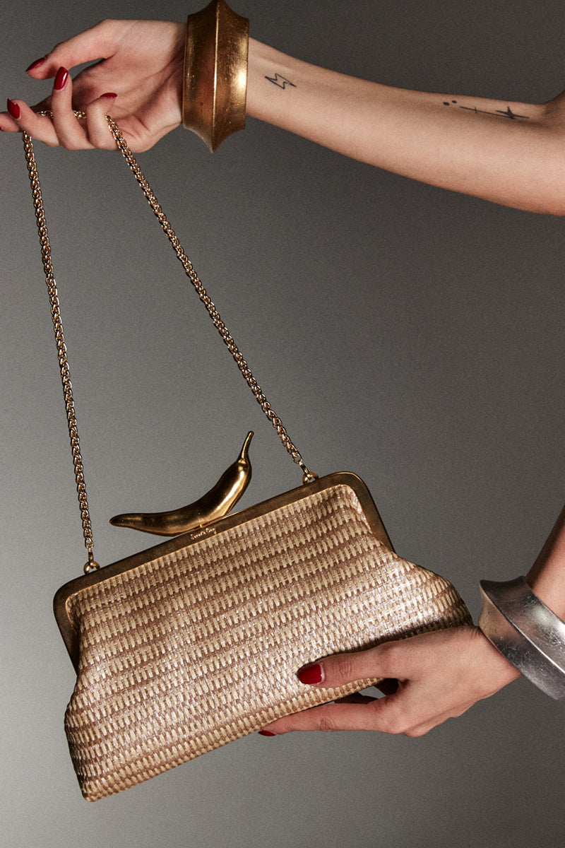 Gold chili straw classic clutch by Sarah's Bag with gold-toned straw exterior and elegant design for evening occasions.