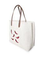 Sarah's Bag chilli on white travel shoulder bag shown from side view, stylish accessory for travel and daily use.