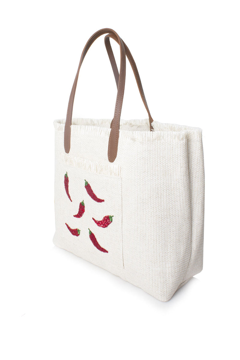 Sarah's Bag chilli on white travel shoulder bag shown from side view, stylish accessory for travel and daily use.