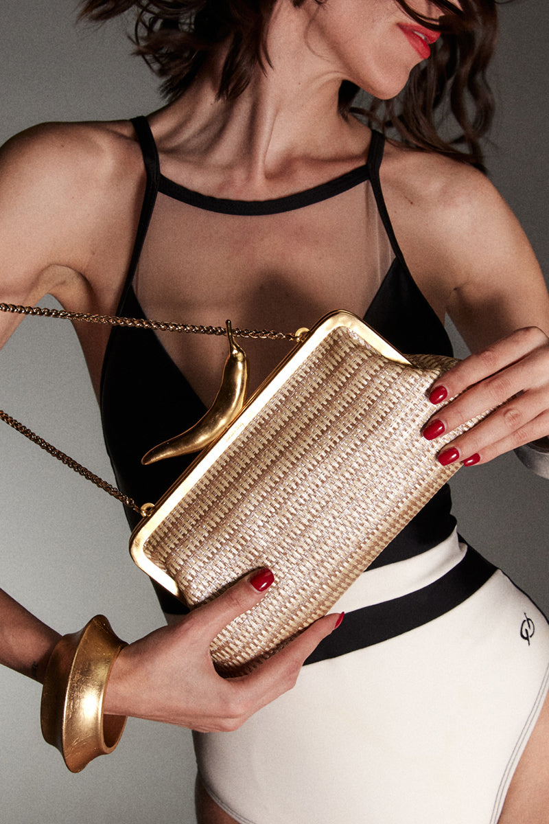 Silver chili straw clutch bag by Sarah's Bag featuring a sleek, metallic design with a chili motif for a stylish accessory.