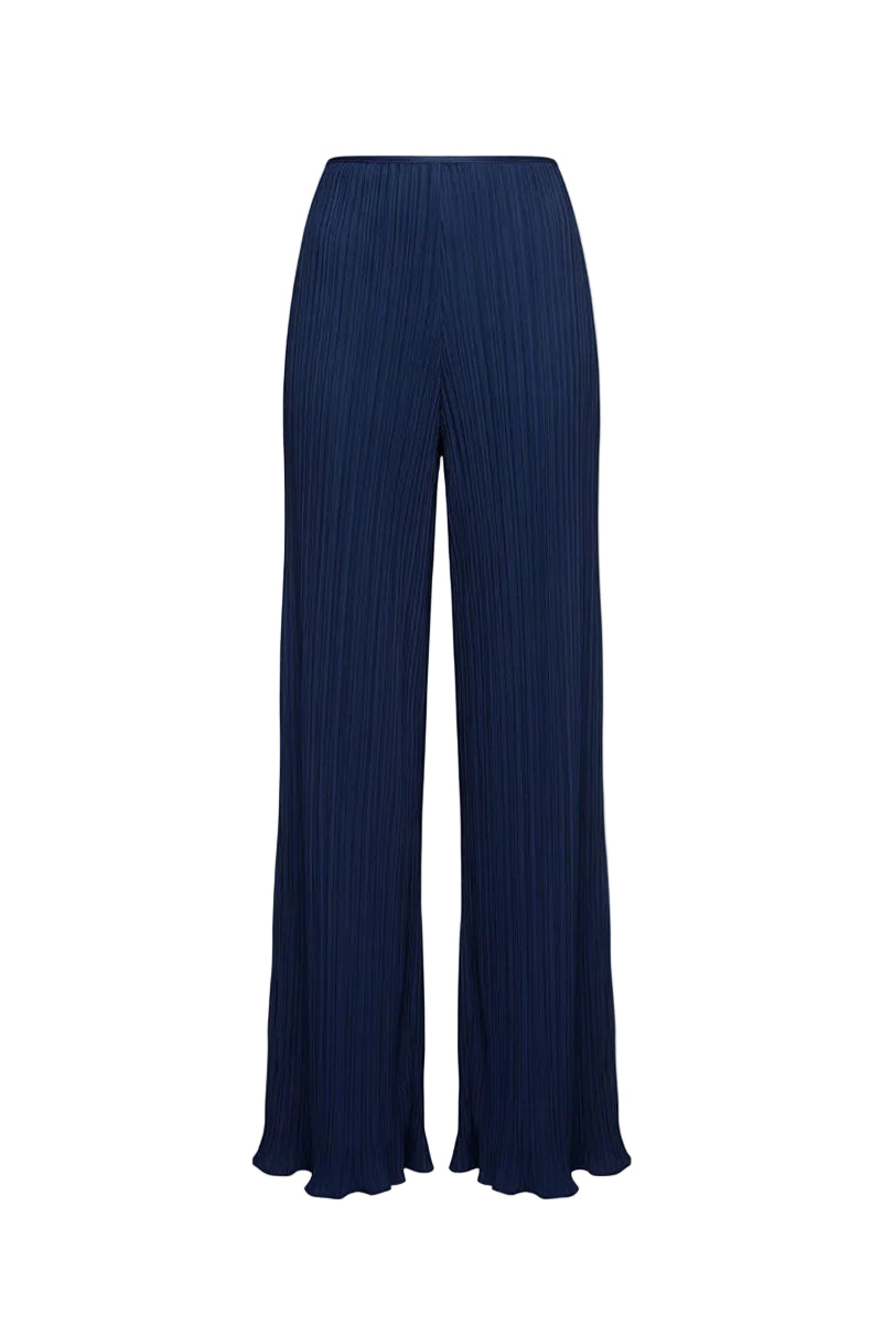 Midnight blue Choza plisse pants by Maylé Vásquez shown on a model with a relaxed fit and elegant pleated design.