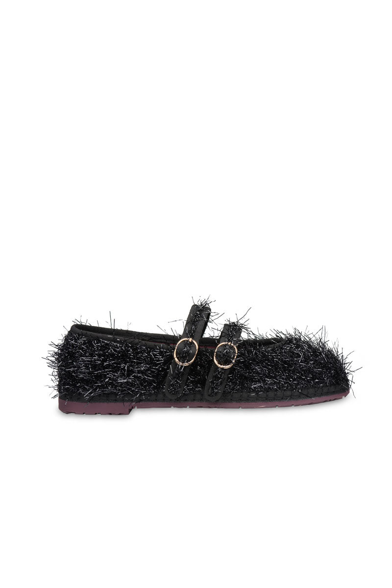 Black flats by Flabelus with sleek design and rounded toe, perfect for casual or professional wear.