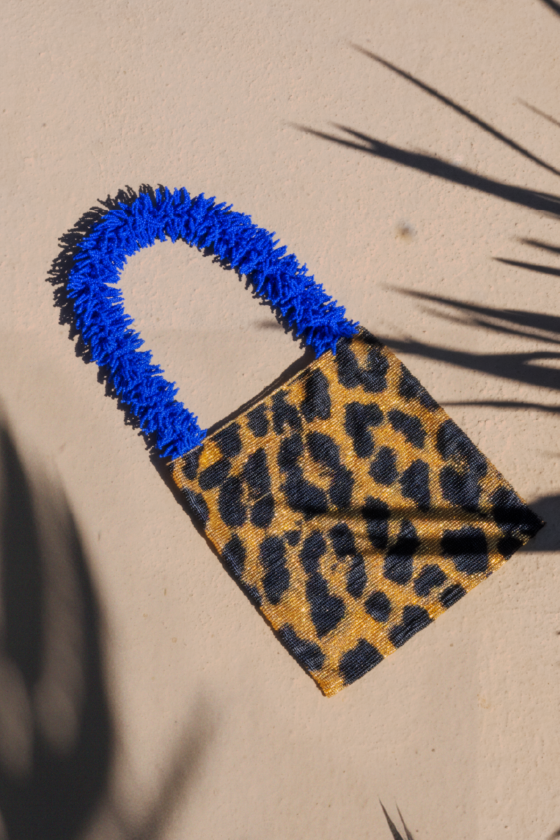 SAC DE SOUL Clash of Prints gold, black, and blue shoulder bag with bold pattern, featuring a stylish design and adjustable strap.