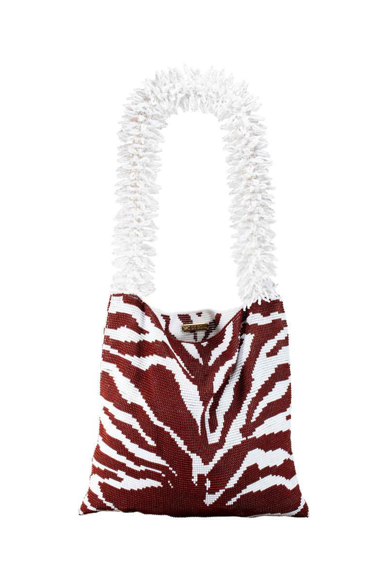Brown and white zebra print shoulder bag by SAC DE SOUL featuring a stylish, patterned design with a flap closure.