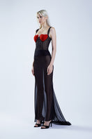 Black fishtail maxi skirt by Stolen Stores, featuring a classic silhouette and elegant length, paired with a black and red bustier.