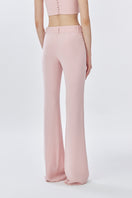 Back view of dusty pink classic long pants by Stolen Stores, featuring a relaxed fit and smooth fabric.