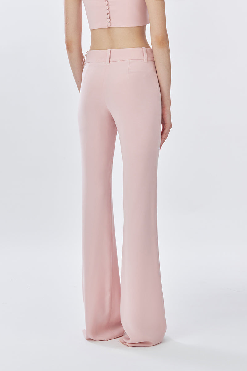 Back view of dusty pink classic long pants by Stolen Stores, featuring a relaxed fit and smooth fabric.