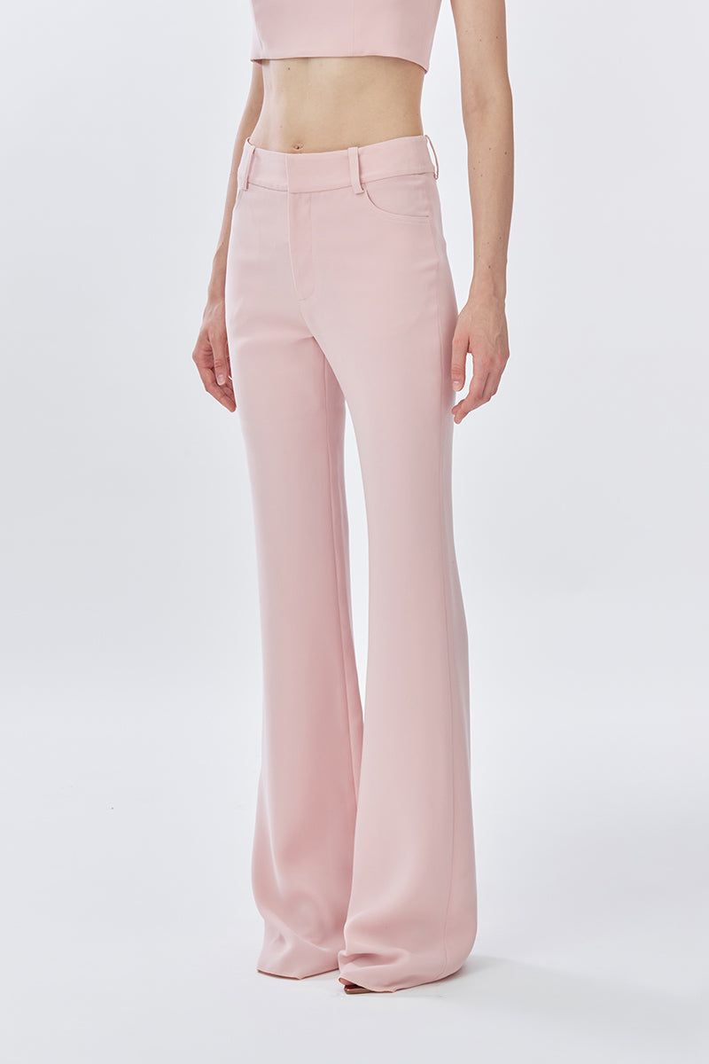Dusty pink classic long pants by Stolen Stores, shown from the front with a relaxed fit and simple design.