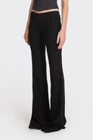 Black low waist pants from Stolen Stores featuring a classic design and relaxed fit, suitable for casual or trendy looks.