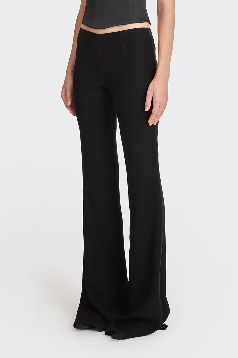 Black low waist pants from Stolen Stores featuring a classic design and relaxed fit, suitable for casual or trendy looks.