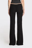 Black low waist pants by Stolen Stores, featuring a classic fit and stylish design shown on a model.