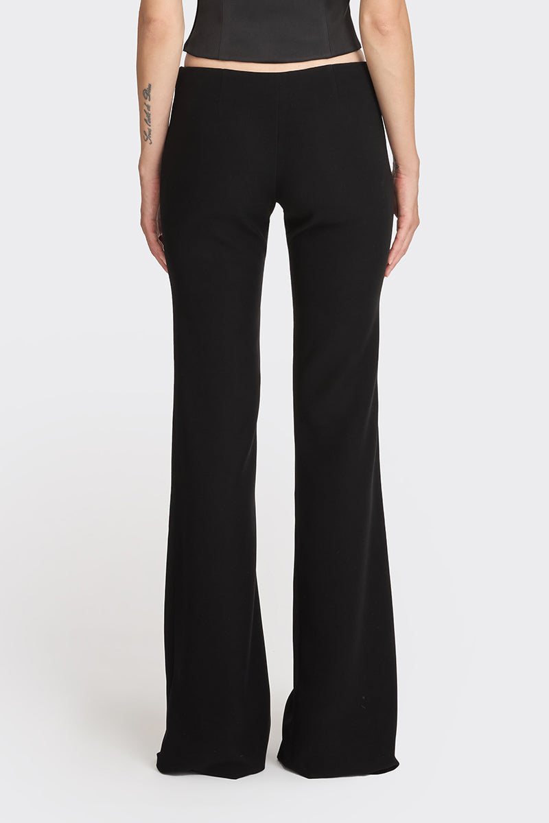 Black low waist pants by Stolen Stores, featuring a classic fit and stylish design shown on a model.