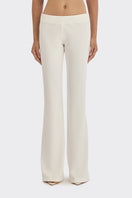 Off-white classic low waist pants by Stolen Stores, shown on model, with relaxed fit and stylish design.