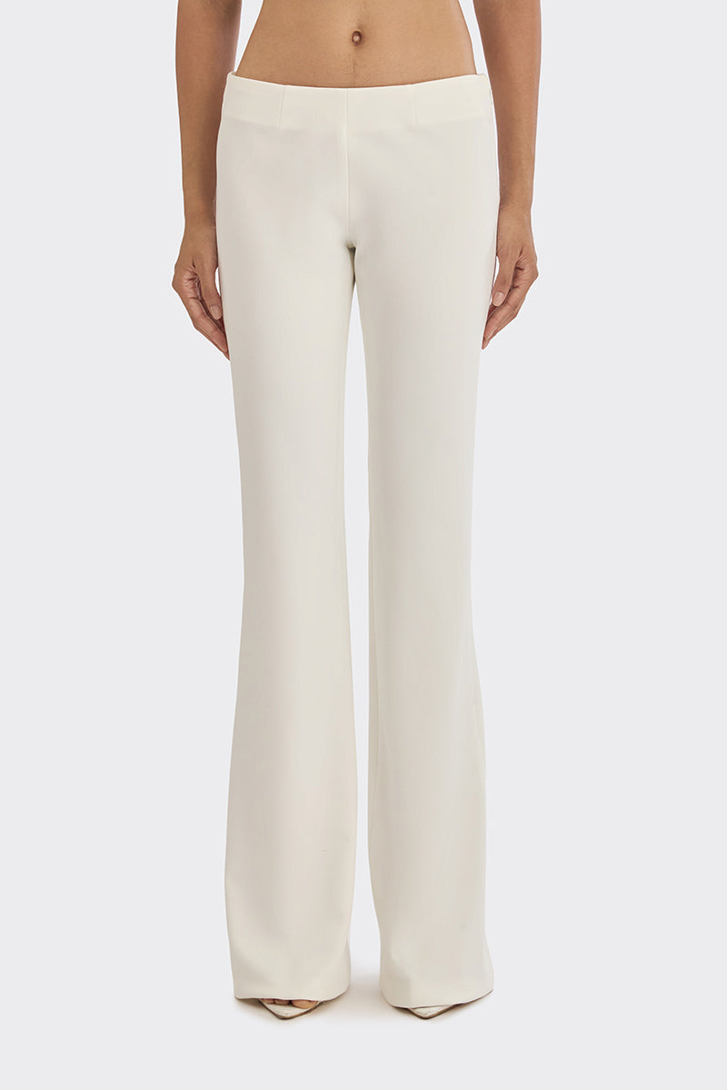 Off-white classic low waist pants by Stolen Stores, shown on model, with relaxed fit and stylish design.