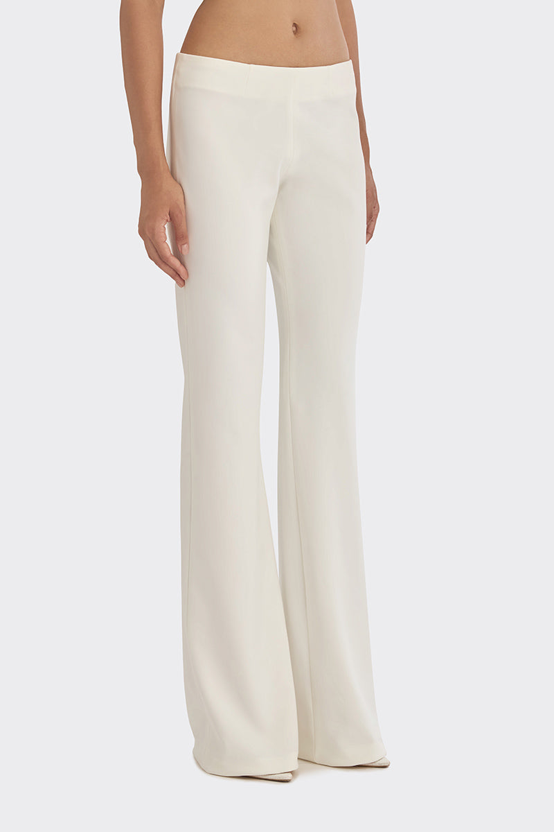 Off white classic low waist pants by Stolen Stores, featuring a relaxed fit and minimal design, shown on a model.