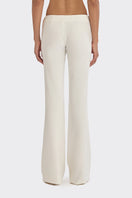 Off-white classic low waist pants by Stolen Stores, shown on model, featuring relaxed fit and modern style.