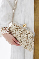 Sarah's Bag clutch with a pomegranate and gold smocking design, featuring a classic style and elegant craftsmanship.