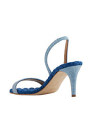 A pair of Claudia blue denim slingback sandals by AERA, featuring open toes and ankle straps on a neutral background.