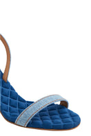 A pair of Claudia blue denim slingback sandals from AERA with open toes and a stylish strap design.