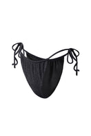 Black Claudia bikini bottom by Suncillo, featuring sleek fabric and classic cut, shown on a model against a neutral background.