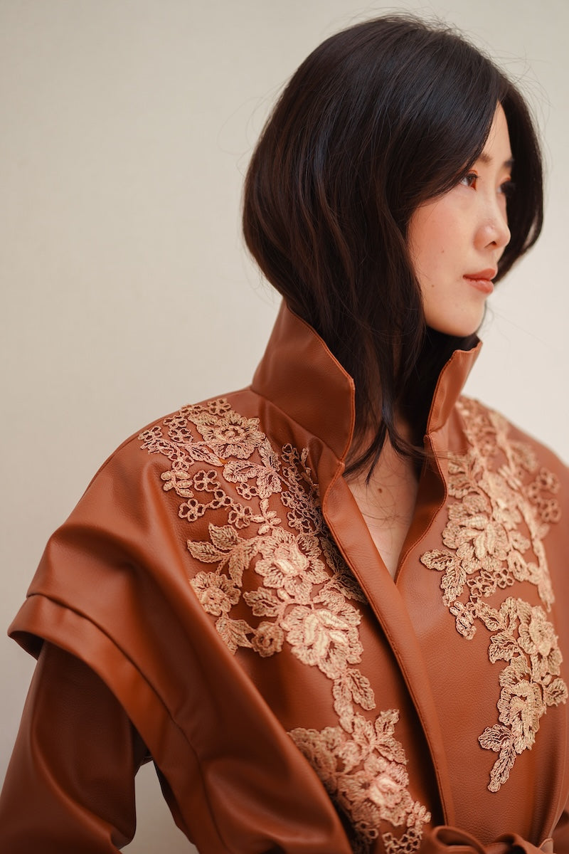 Nadya Shah Cleo faux leather belted jacket featuring a stylish design with a waist belt and sleek black finish.