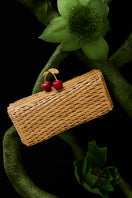 Cherry hand-woven rattan clutch bag by Waiwai Rio with intricate weaving and compact design for stylish carry.