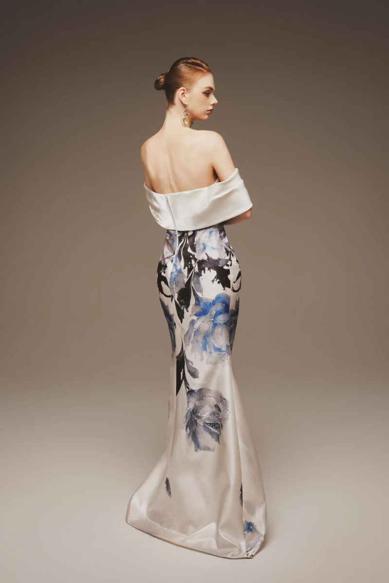 Cobalt blossom strapless maxi gown by Margée Atelier displayed on a hanger, featuring a flowing silhouette and elegant design.