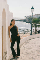 Nana Jacqueline Margaux black jeans featuring a slim fit and classic denim design, shown on a model in a fashion campaign image.