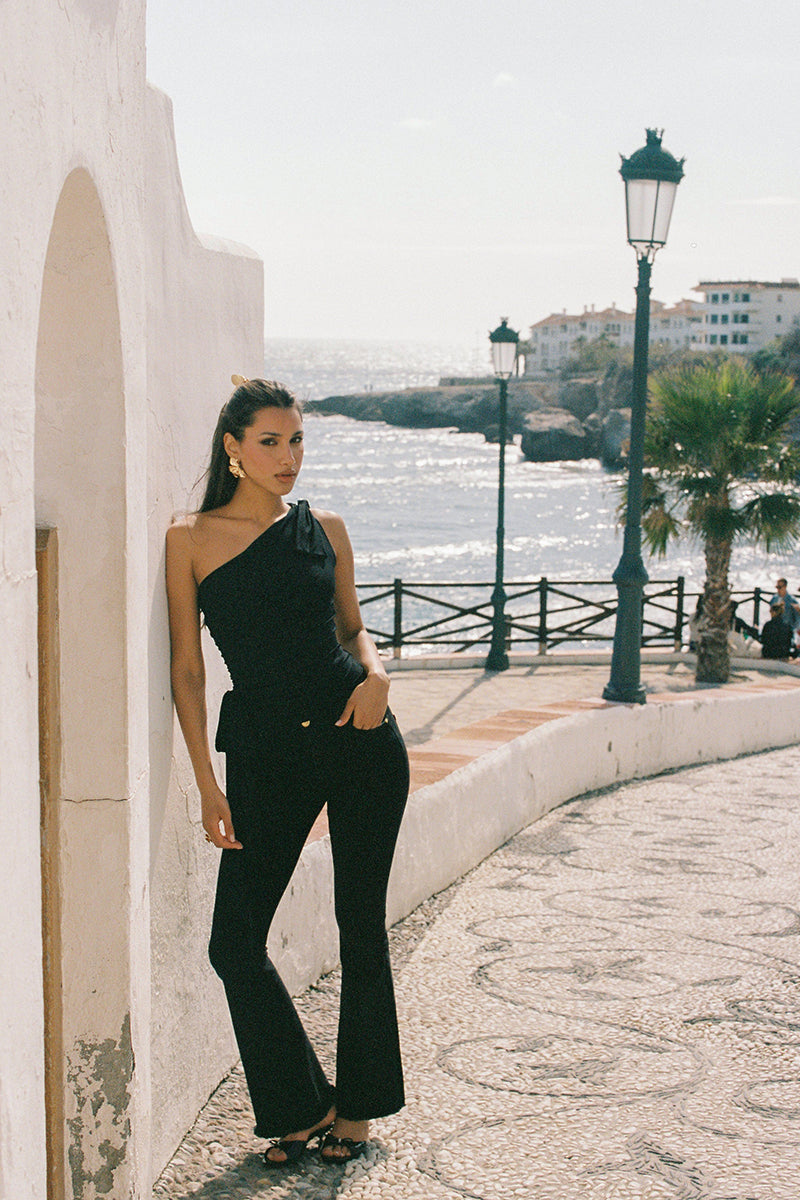 Nana Jacqueline Margaux black jeans featuring a slim fit and classic denim design, shown on a model in a fashion campaign image.