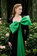 I.H.F column evening gown with trapeze neckline and large attached bow, elegant formal dress with sleek silhouette.