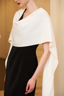 White draped shoulder evening gown by I.H.F featuring a sleek column silhouette and elegant ribbon detail over the shoulder.