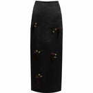 Black YASSMIN SALEH midi column skirt displayed from the front, showcasing its sleek, fitted silhouette and smooth fabric.