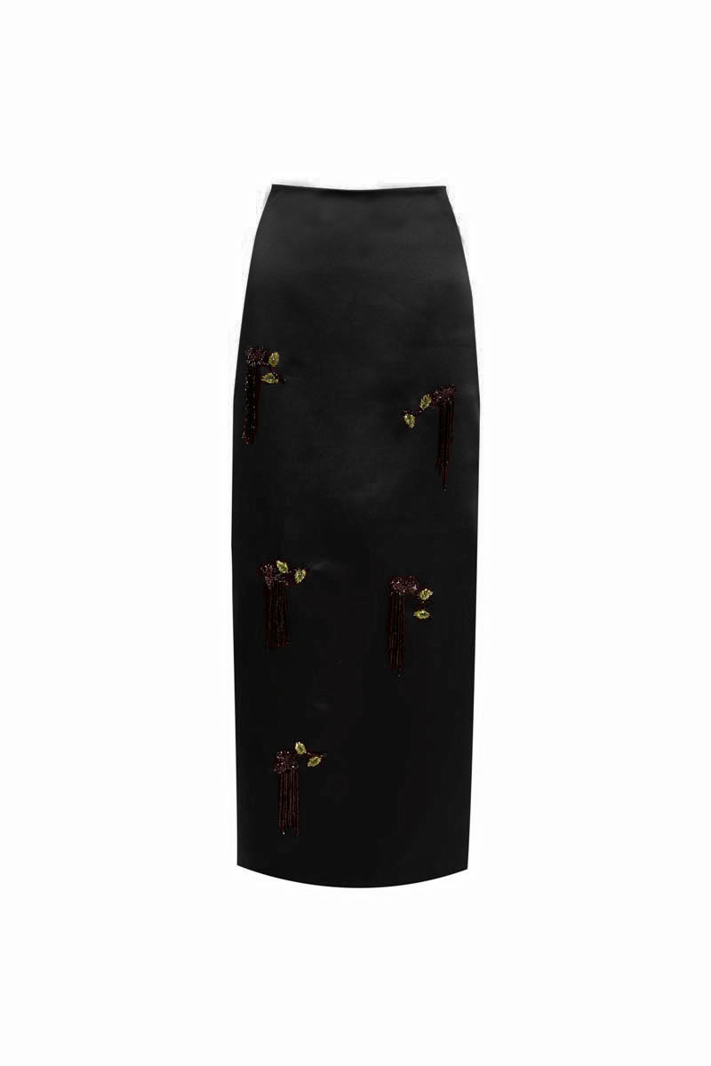 Black YASSMIN SALEH midi column skirt displayed from the front, showcasing its sleek, fitted silhouette and smooth fabric.