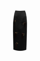 Black YASSMIN SALEH midi column skirt displayed from the front, showcasing its sleek, fitted silhouette and smooth fabric.