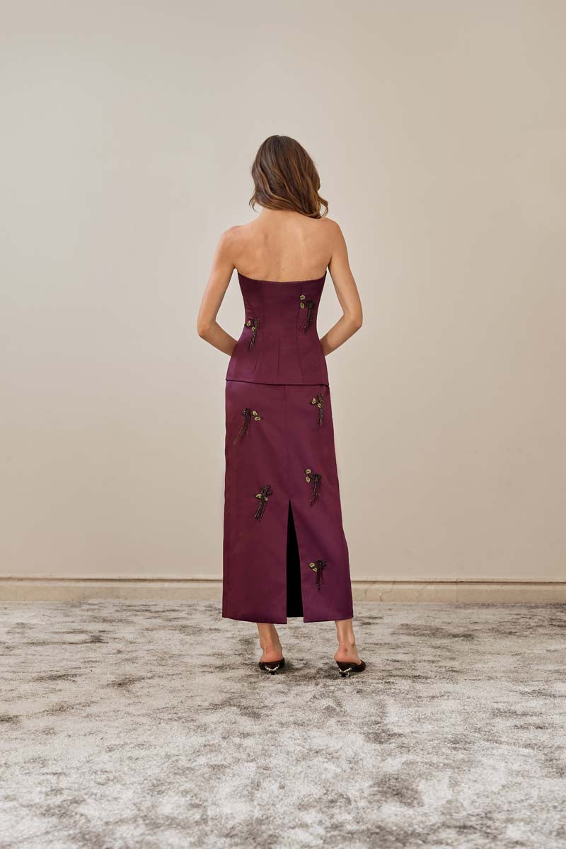 Purple YASSMIN SALEH midi column skirt shown from the back, sleek and fitted with a smooth, elegant silhouette.