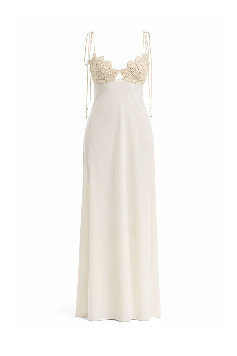 Off-white Concha dress by Maylé Vásquez, elegant gown with flowing fabric and intricate design details.