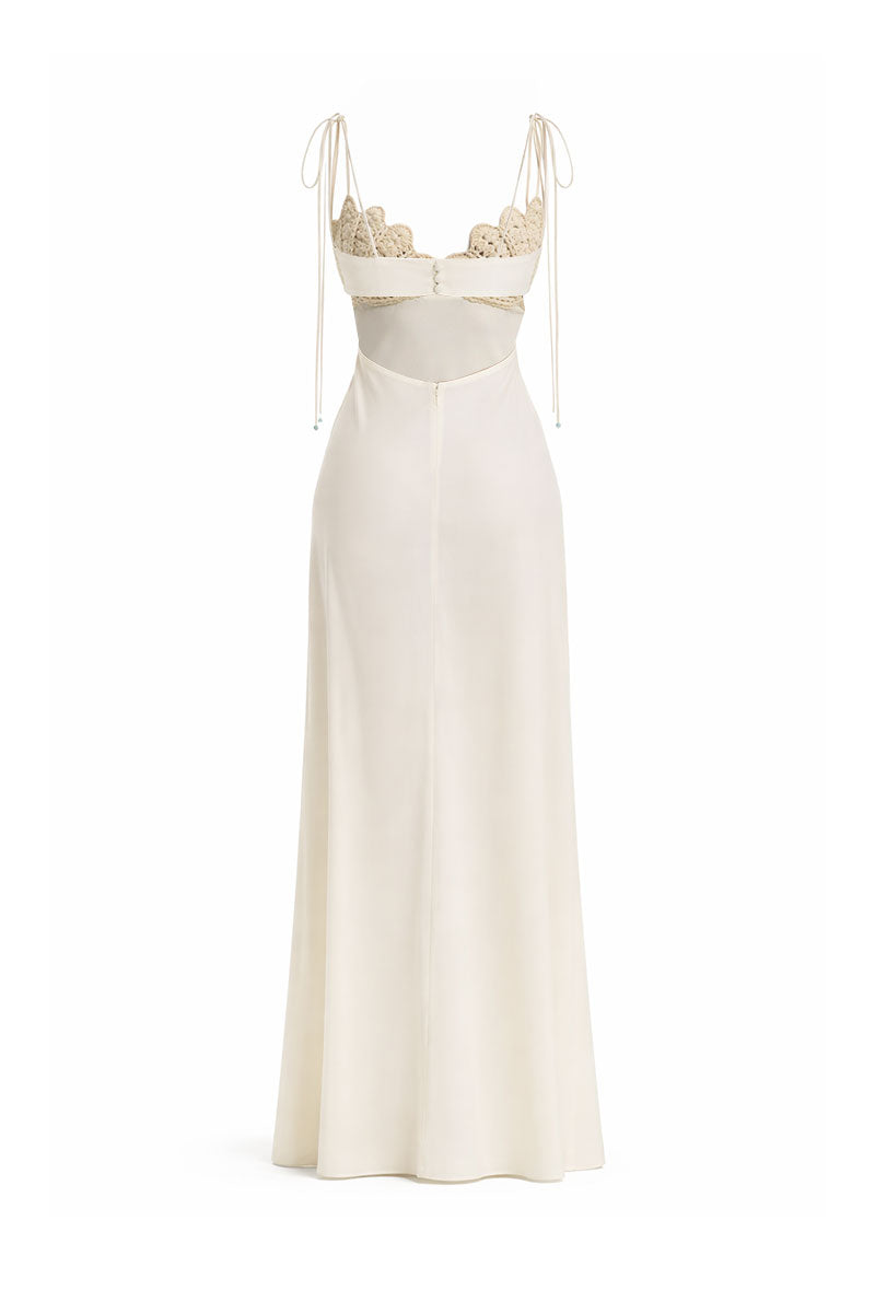 Off-white Concha dress by Maylé Vásquez, elegant gown with flowing fabric and subtle detailing, perfect for formal occasions.