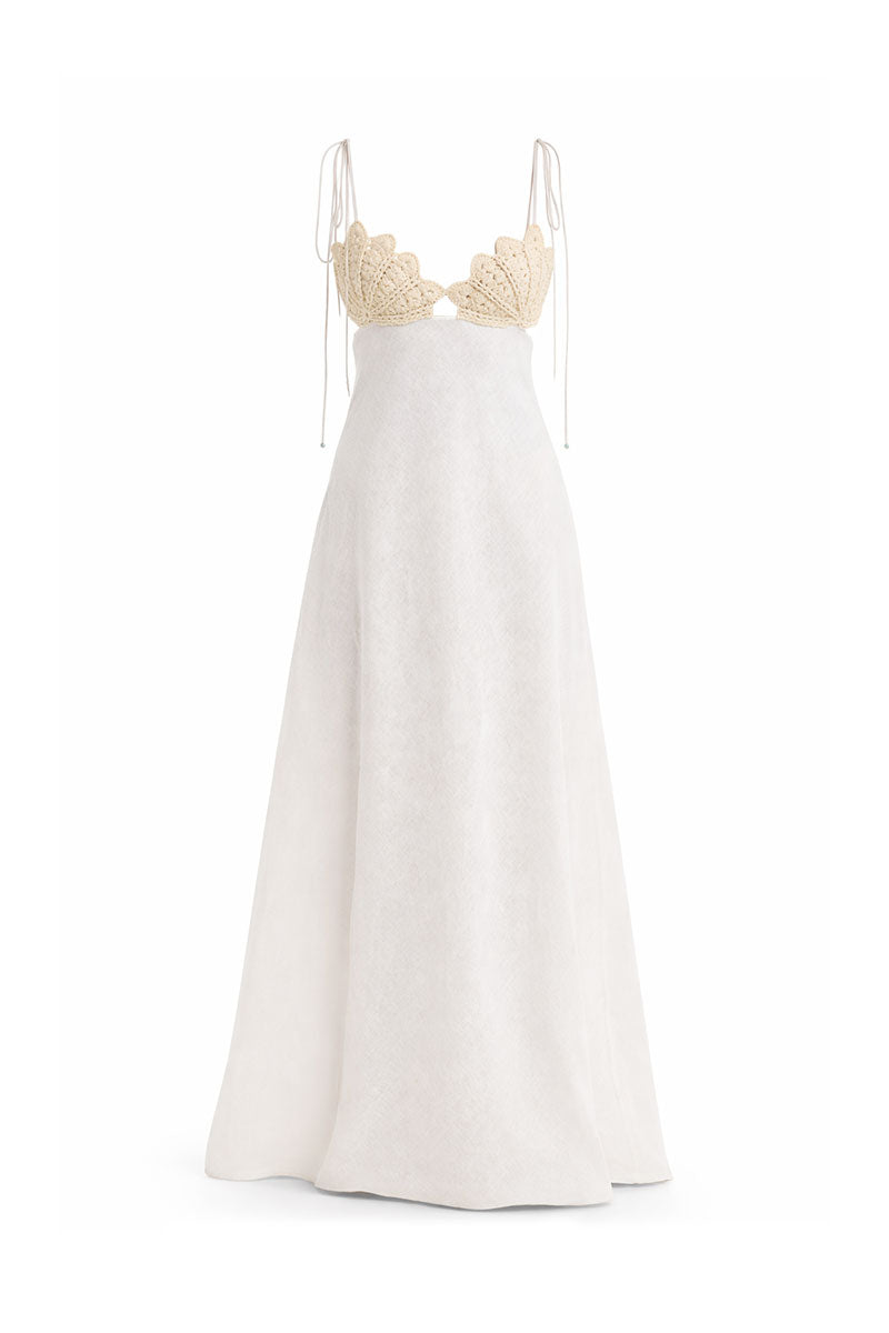 Off-white Conchita gown by Maylé Vásquez, elegant formal dress with flowing fabric and intricate design details.