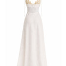 Off-white Conchita gown by Maylé Vásquez with intricate lace details and flowing fabric, elegant evening dress for formal occasions