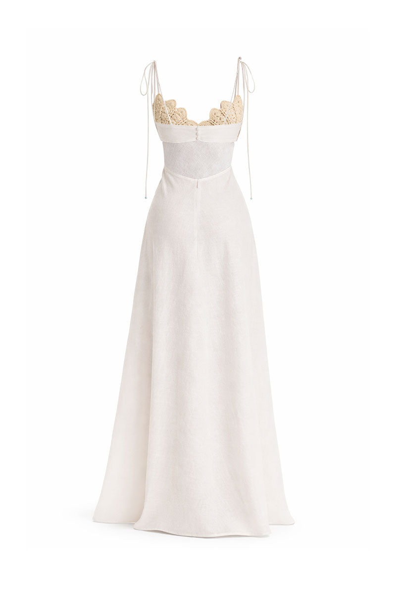 Off-white Conchita gown by Maylé Vásquez featuring elegant fabric and flowing design, perfect for formal occasions.