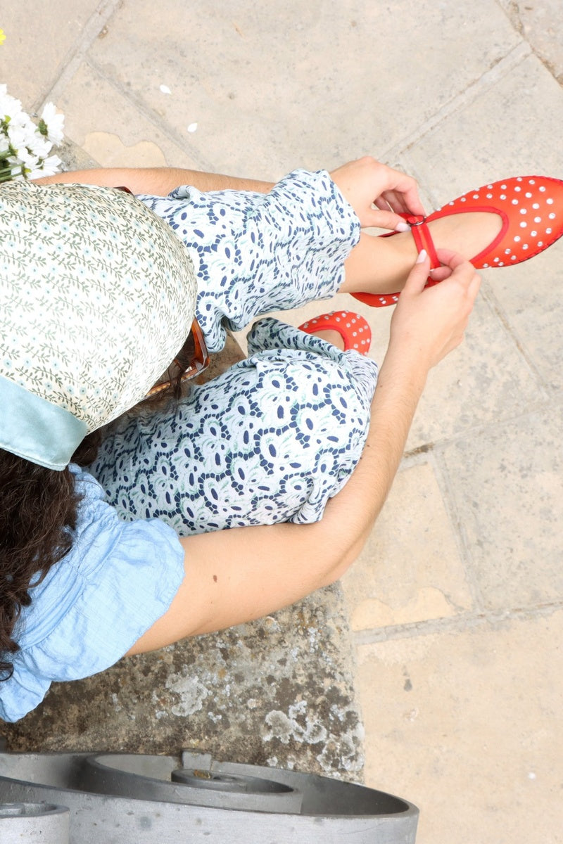 Flabelus Mae red flats with pointed toes and sleek design, shown on a white background.