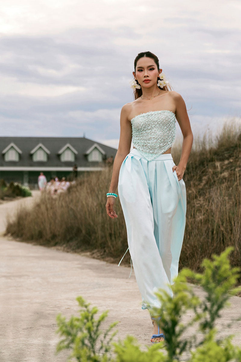 Sky blue balloon pants by Valenciani featuring a loose, billowy fit with elastic waist and cuffs, styled with casual footwear.