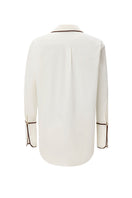 White boyfriend shirt by IKINITA, shown flat with collar and buttons, highlighting casual yet stylish design.