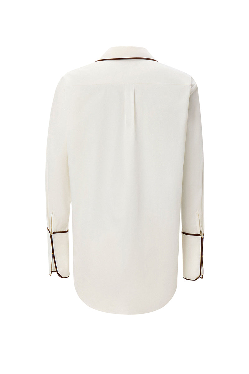 White boyfriend shirt by IKINITA, shown flat with collar and buttons, highlighting casual yet stylish design.