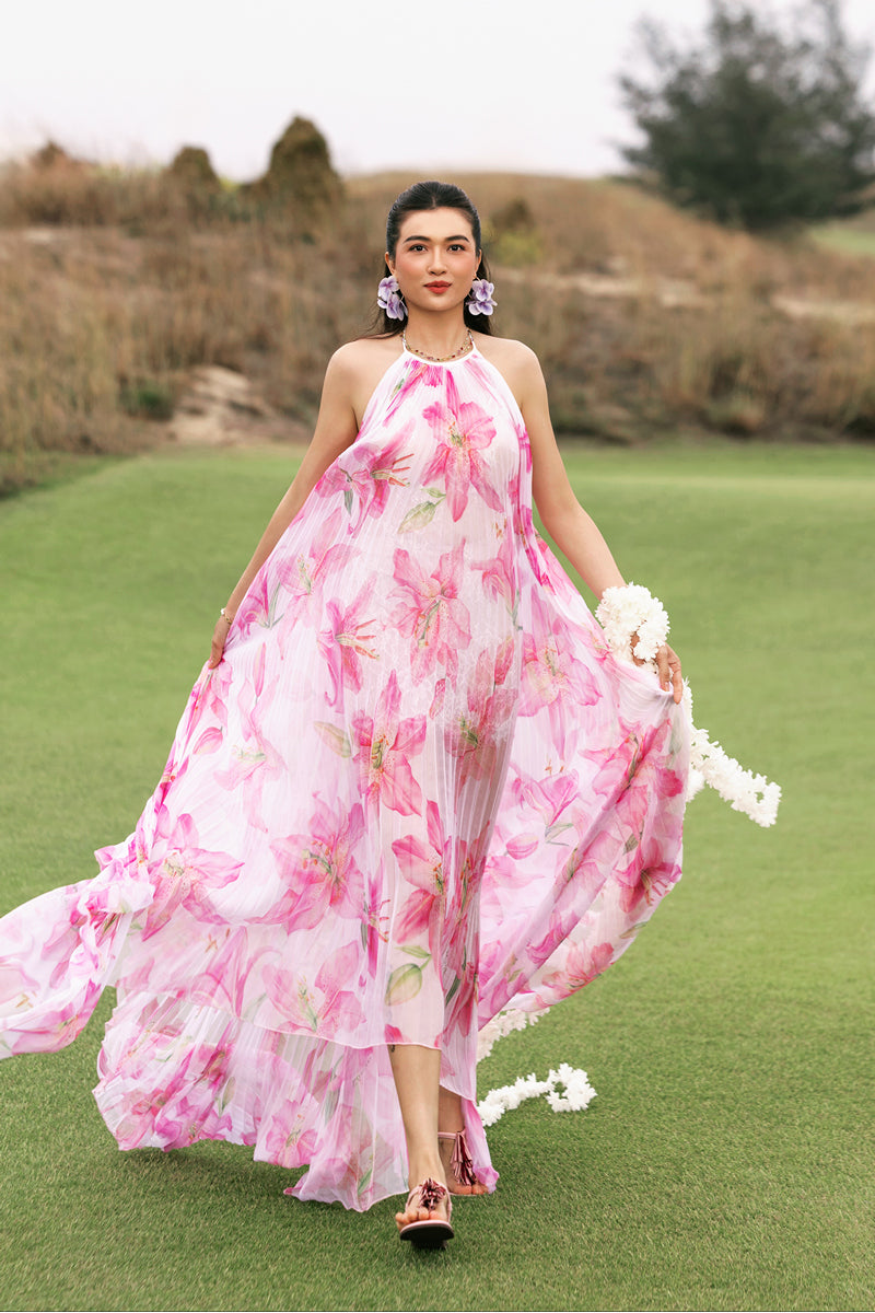 Multicolor halter neck pleated maxi dress by Valenciani, flowing fabric with a stylish silhouette and vibrant pattern.